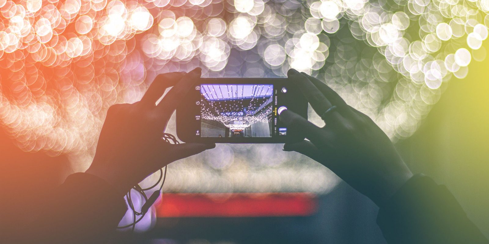 woman-photographing-city-lights-at-night-with-mobile-phone_s